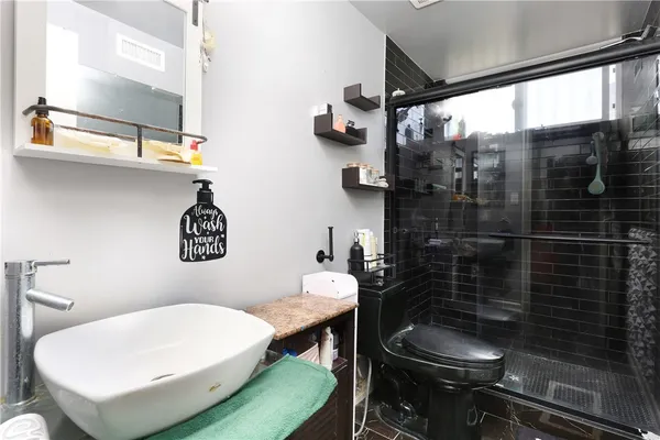 a bathroom with a toilet and a shower