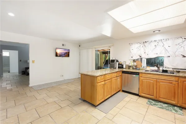 a kitchen with stainless steel appliances granite countertop a sink and cabinets