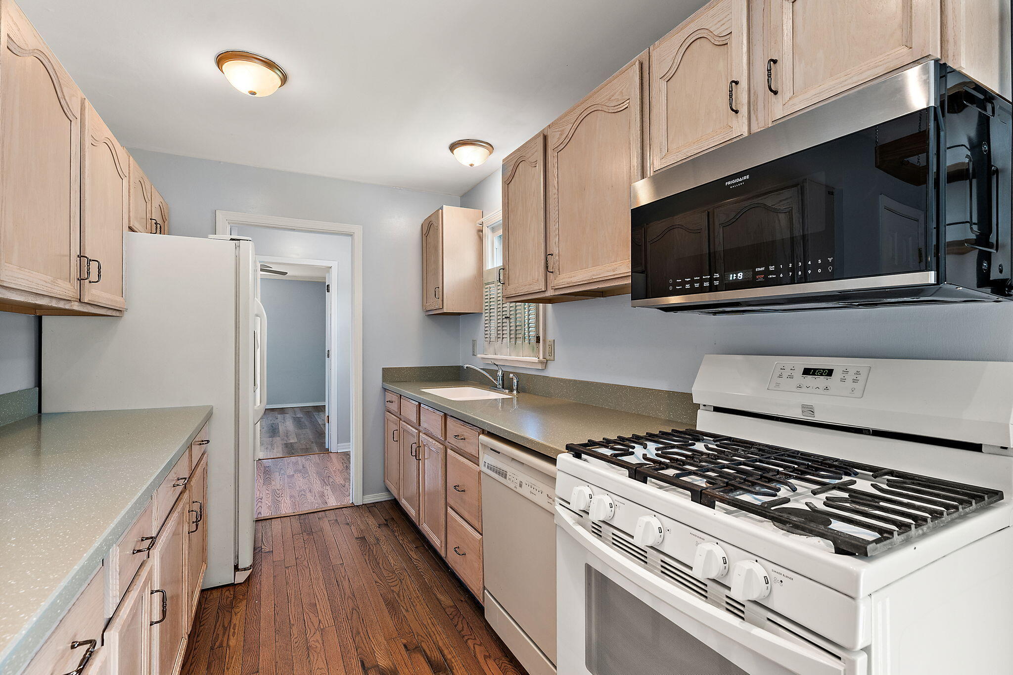 739 Eagle Creek Road Valparaiso, IN 46385 - Photo 11 of 23 a kitchen with stainless steel appliances a stove a microwave a sink and cabinets