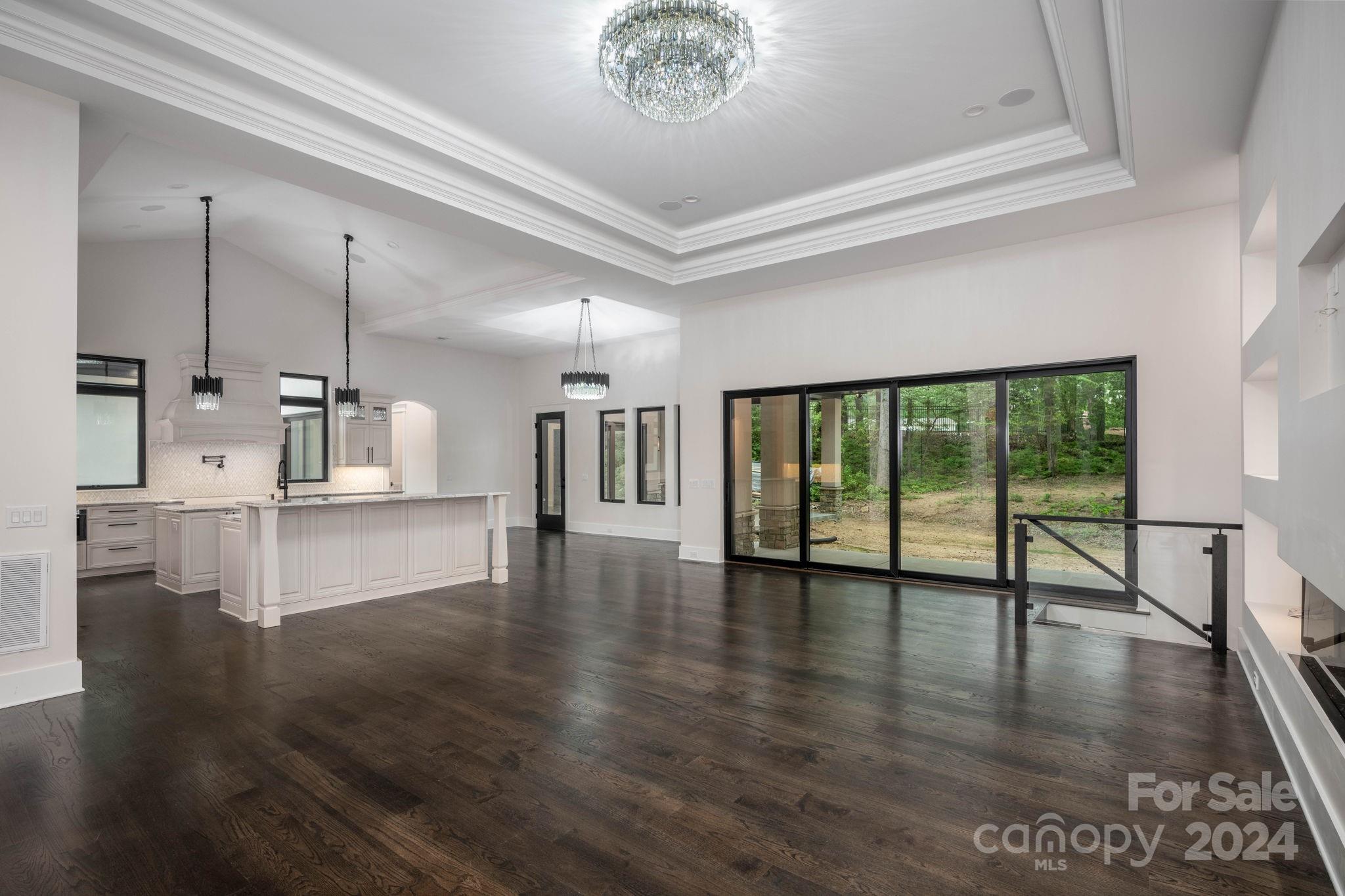 10290 Enclave Circle Concord, NC 28027 - Photo 17 of 48 a view of an empty room with wooden floor and a window