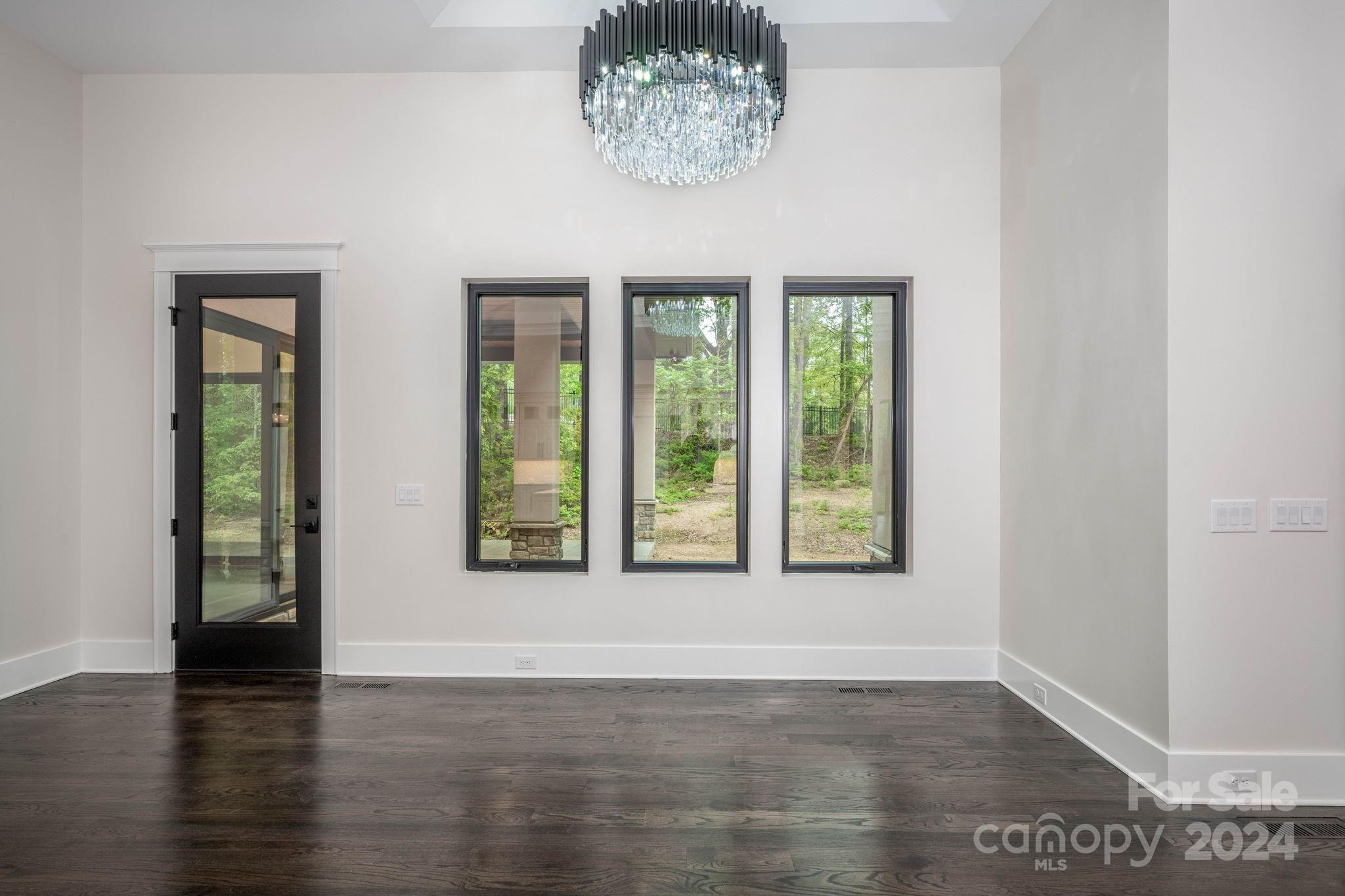 10290 Enclave Circle Concord, NC 28027 - Photo 26 of 48 an empty room with wooden floor and windows