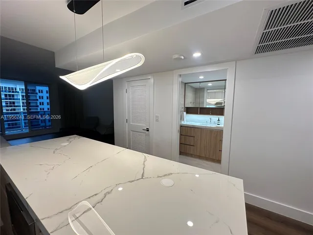 a bedroom with a bed and a view of kitchen