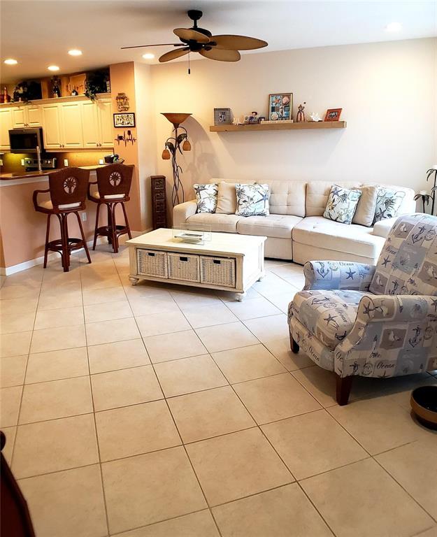 5662 Whitehead Street Bradenton, FL 34203 - Photo 11 of 51 a living room with furniture and a kitchen view