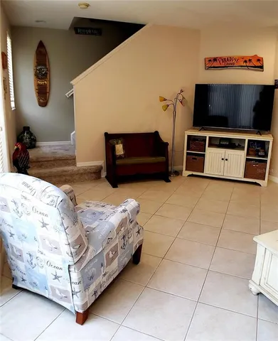 a kitchen with a table chairs refrigerator and microwave
