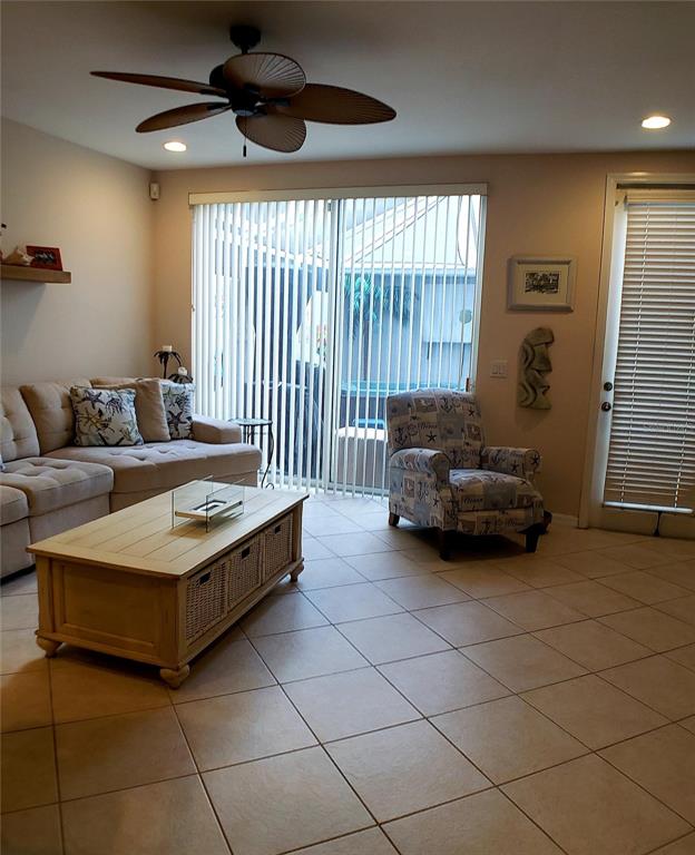 5662 Whitehead Street Bradenton, FL 34203 - Photo 13 of 51 a living room with furniture and a chandelier