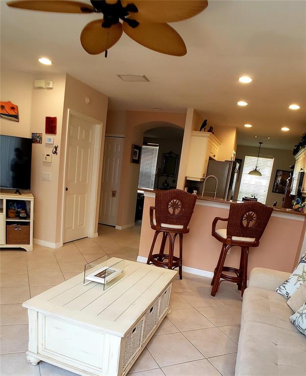 5662 Whitehead Street Bradenton, FL 34203 - Photo 14 of 51 a room with furniture and a flat screen tv