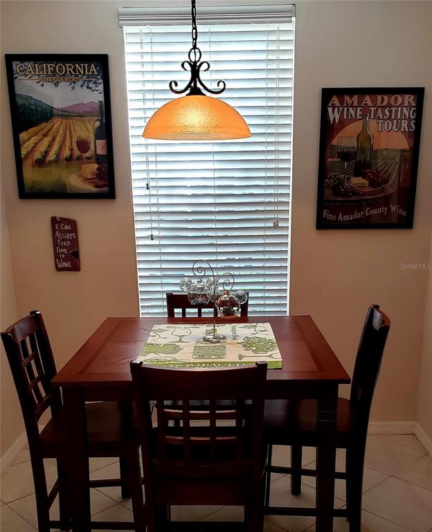 5662 Whitehead Street Bradenton, FL 34203 - Photo 25 of 51 a view of a dining room with furniture and wooden floor