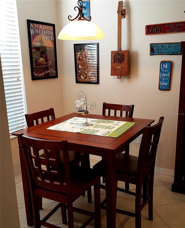 5662 Whitehead Street Bradenton, FL 34203 - Photo 26 of 51 a dining room with furniture and wooden floor