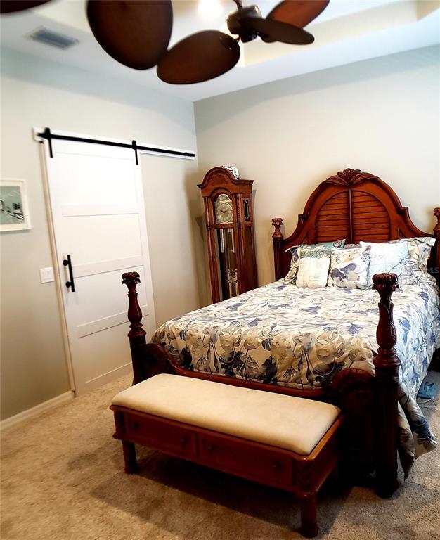 5662 Whitehead Street Bradenton, FL 34203 - Photo 30 of 51 a bedroom with a bed and lamp
