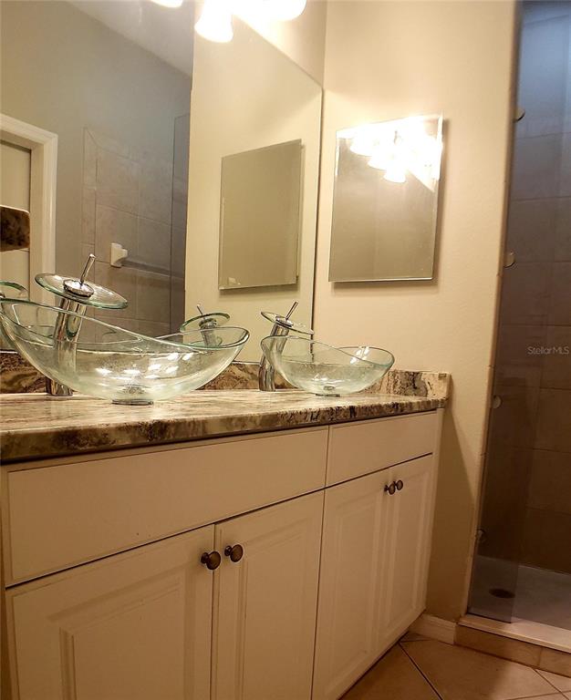 5662 Whitehead Street Bradenton, FL 34203 - Photo 35 of 51 a bathroom with a granite countertop sink and a mirror