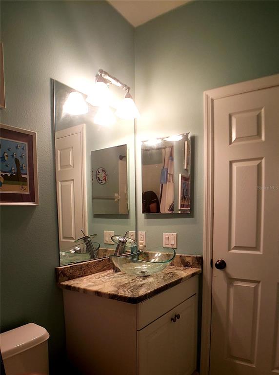 5662 Whitehead Street Bradenton, FL 34203 - Photo 40 of 51 a bathroom with a granite countertop sink and a mirror