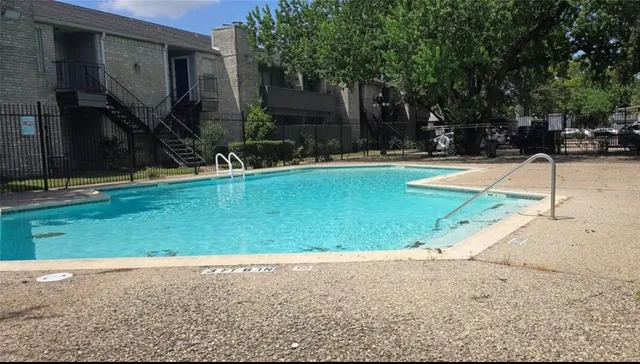 a swimming pool with outdoor seating and yard
