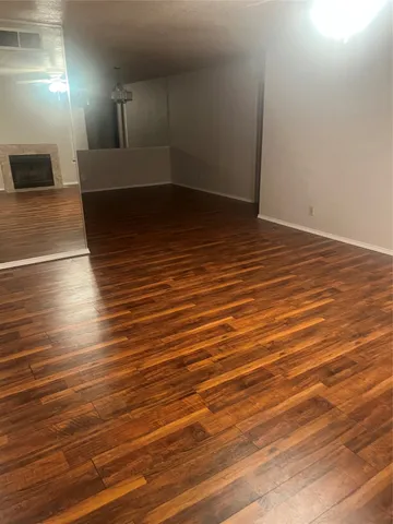 an empty room with wooden floor