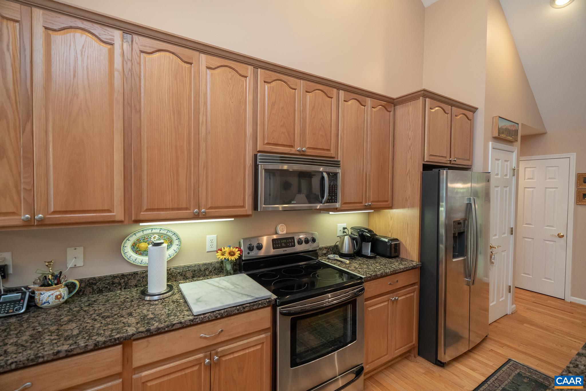 9 Hawks Place Palmyra, VA 22963 - Photo 17 of 63 a kitchen with granite countertop wood cabinets stainless steel appliances and a sink