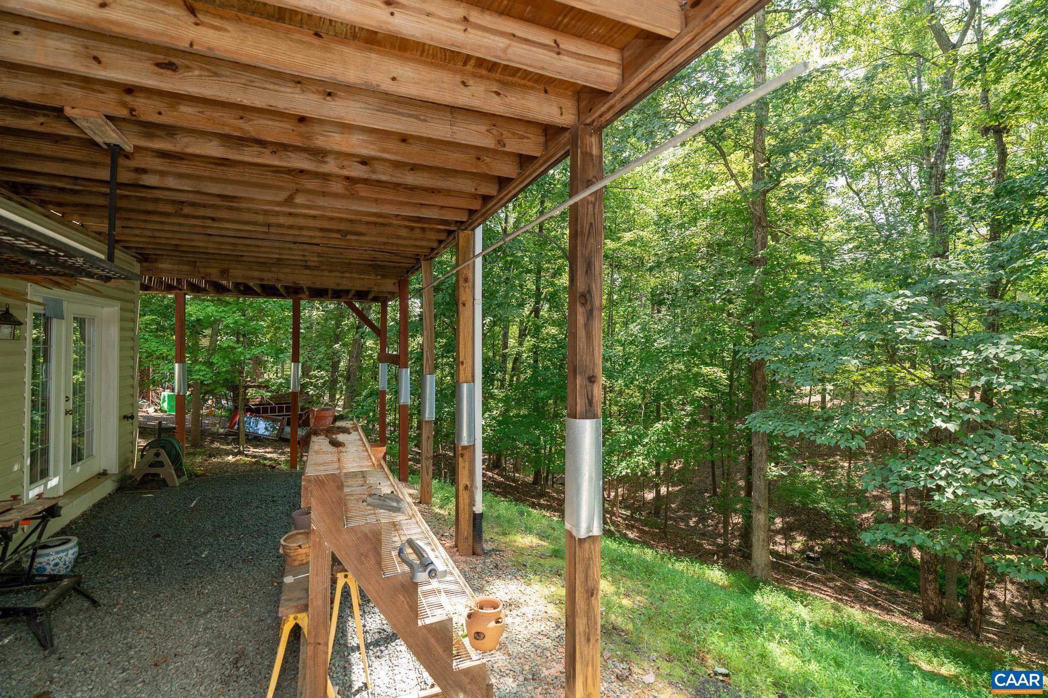 9 Hawks Place Palmyra, VA 22963 - Photo 52 of 63 a view of a patio with table and chairs under an umbrella