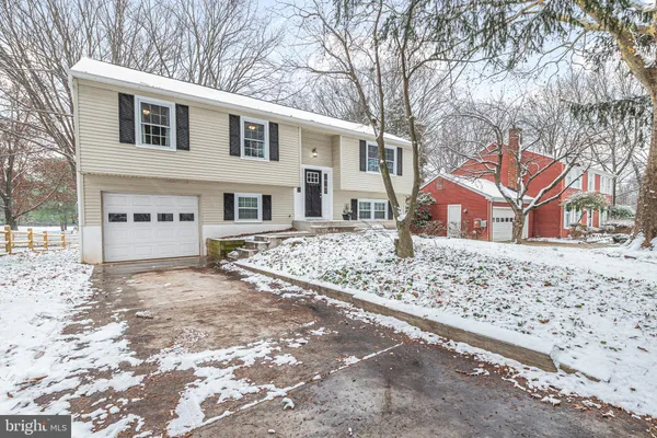 a view of a house with a yard covered in snow