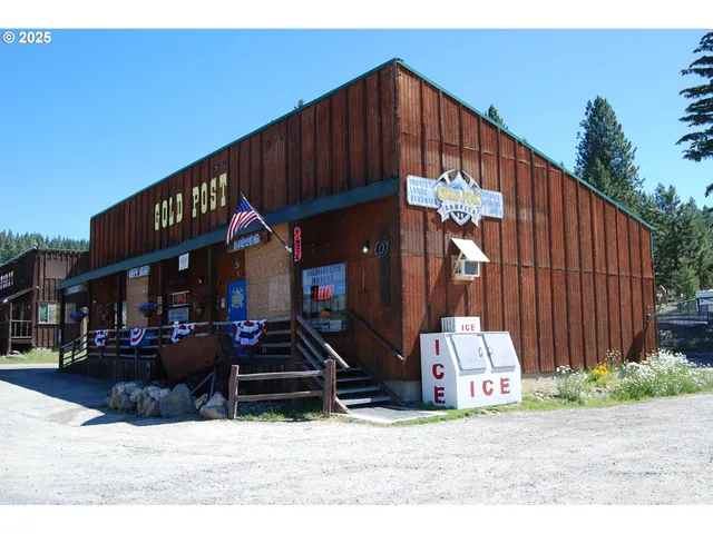 a street view with wooden fence and a potted plant