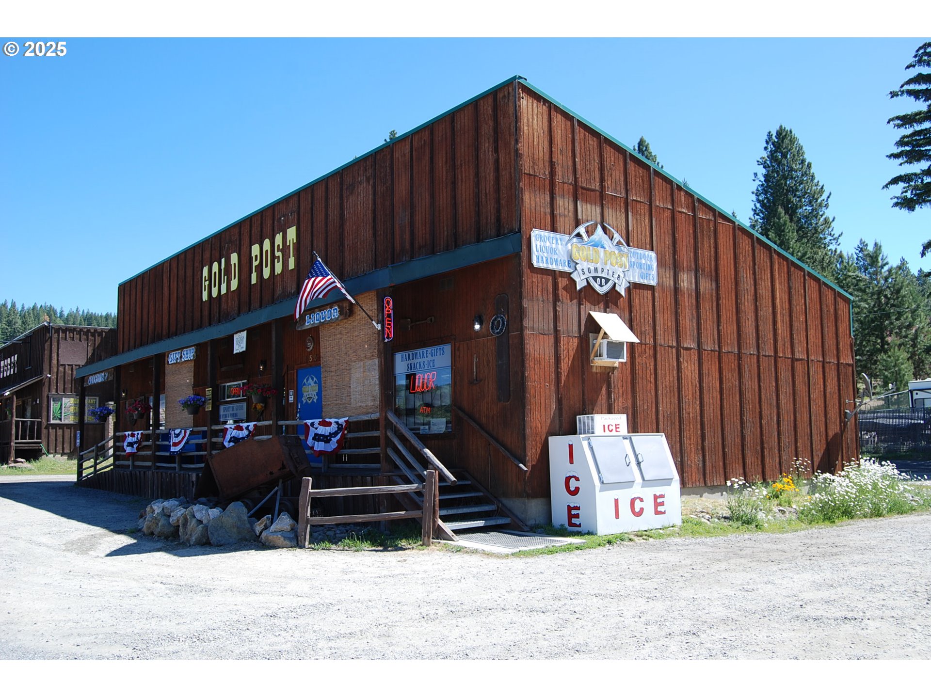 150 Mill Street Sumpter, OR 97877 - Photo 9 of 47 a street view with wooden fence and a potted plant