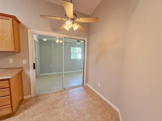 an empty room with fan and entrance