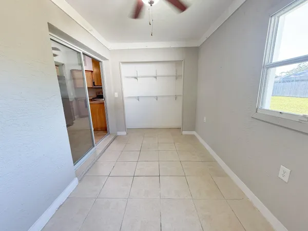 a view of a livingroom with a ceiling fan and window