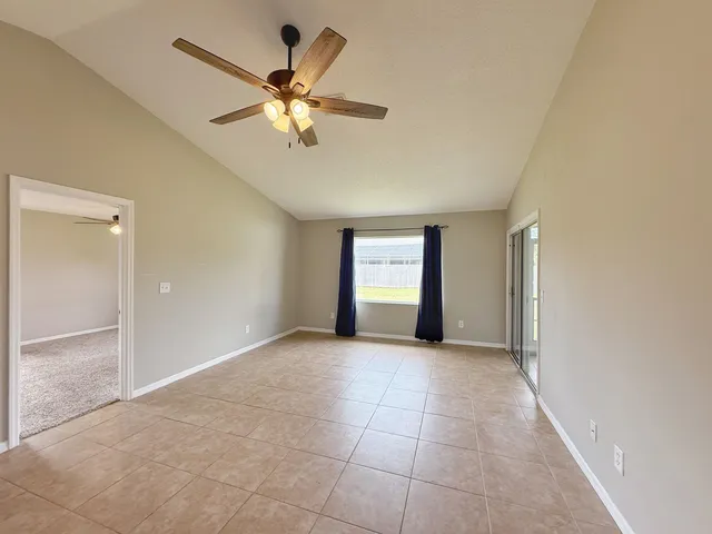 a view of an empty room with a ceiling fan