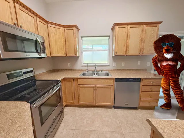 a kitchen with granite countertop a stove sink and cabinets