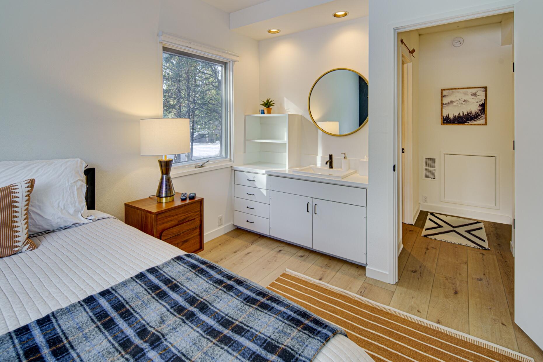 57257 Island Road Sunriver, OR 97707 - Photo 22 of 27 a bedroom with a bed a dresser and mirror