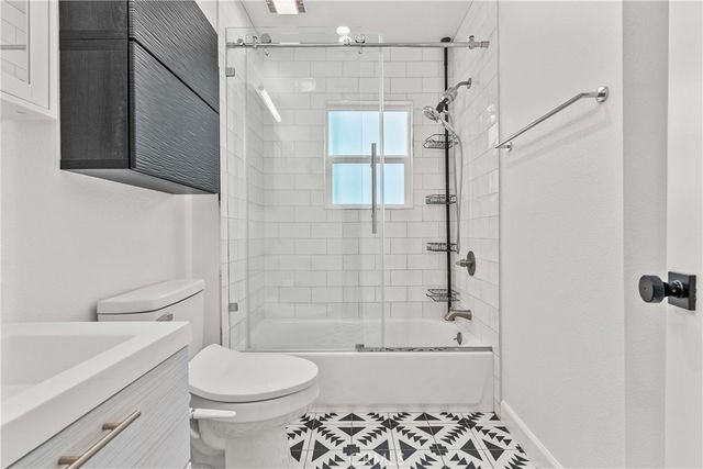 a bathroom with a toilet a sink and shower