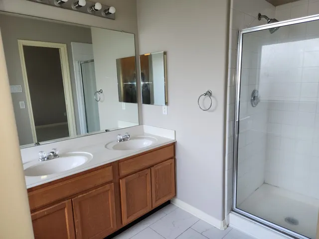 a bathroom with a double vanity sink and mirror