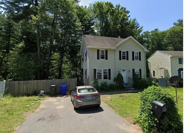 a car parked in front of white house