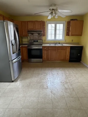 a kitchen with stainless steel appliances granite countertop a refrigerator and a sink