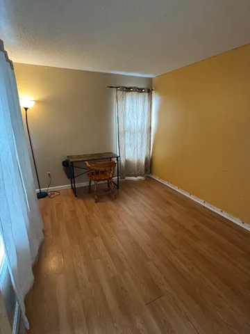 a view of a room with wooden floor and chair