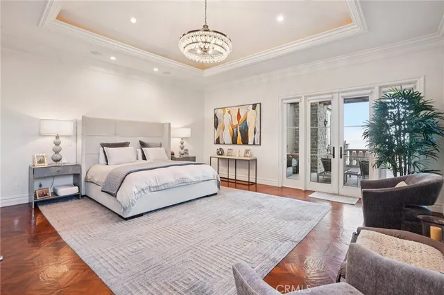an aerial view of ocean and residential houses with outdoor space