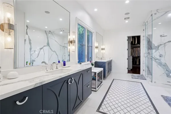 a bathroom with a granite countertop sink mirror vanity and toilet
