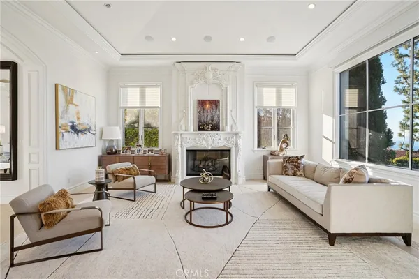 a dining room with furniture potted plants and a chandelier fan