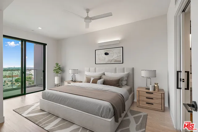 a bedroom with a bed and a night stand