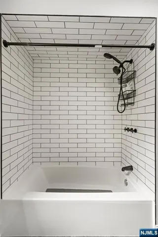 a bathroom with a shower and a bathtub
