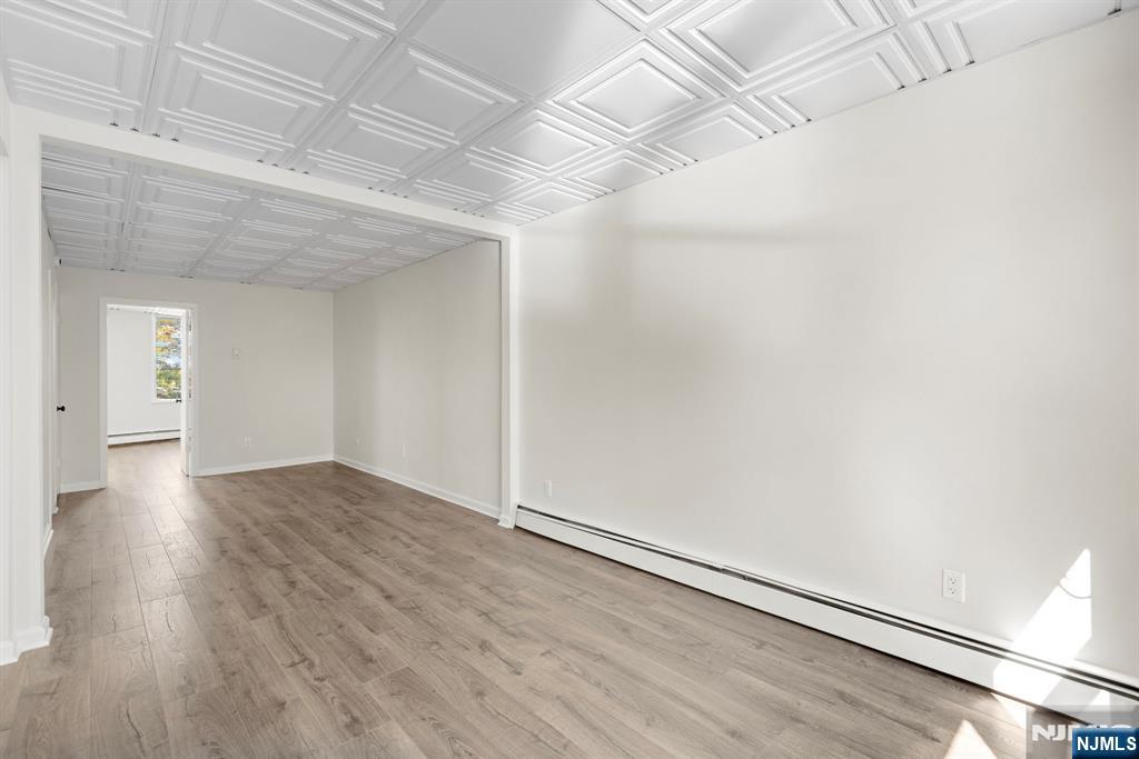 1534 Paterson Plank Road, Unit 2 Secaucus, NJ 07094 - Photo 4 of 17 an empty room with wooden floor