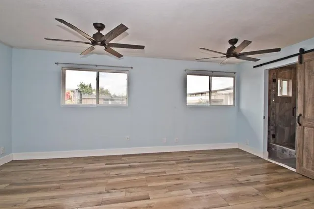 a view of a livingroom with a ceiling fan and window