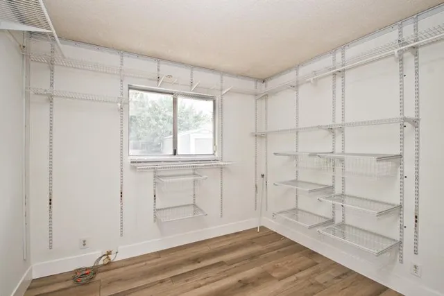 a view of walk in closet with empty racks