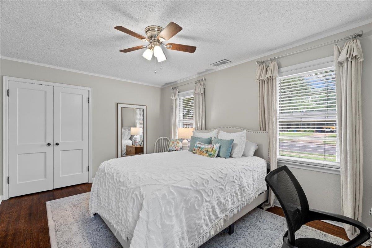 4491 Garnett Road Memphis, TN 38117 - Photo 20 of 32 Bedroom featuring wood-finish flooring, two large windows with blinds, a ceiling fan with light fixture, and double bi-fold closet doors