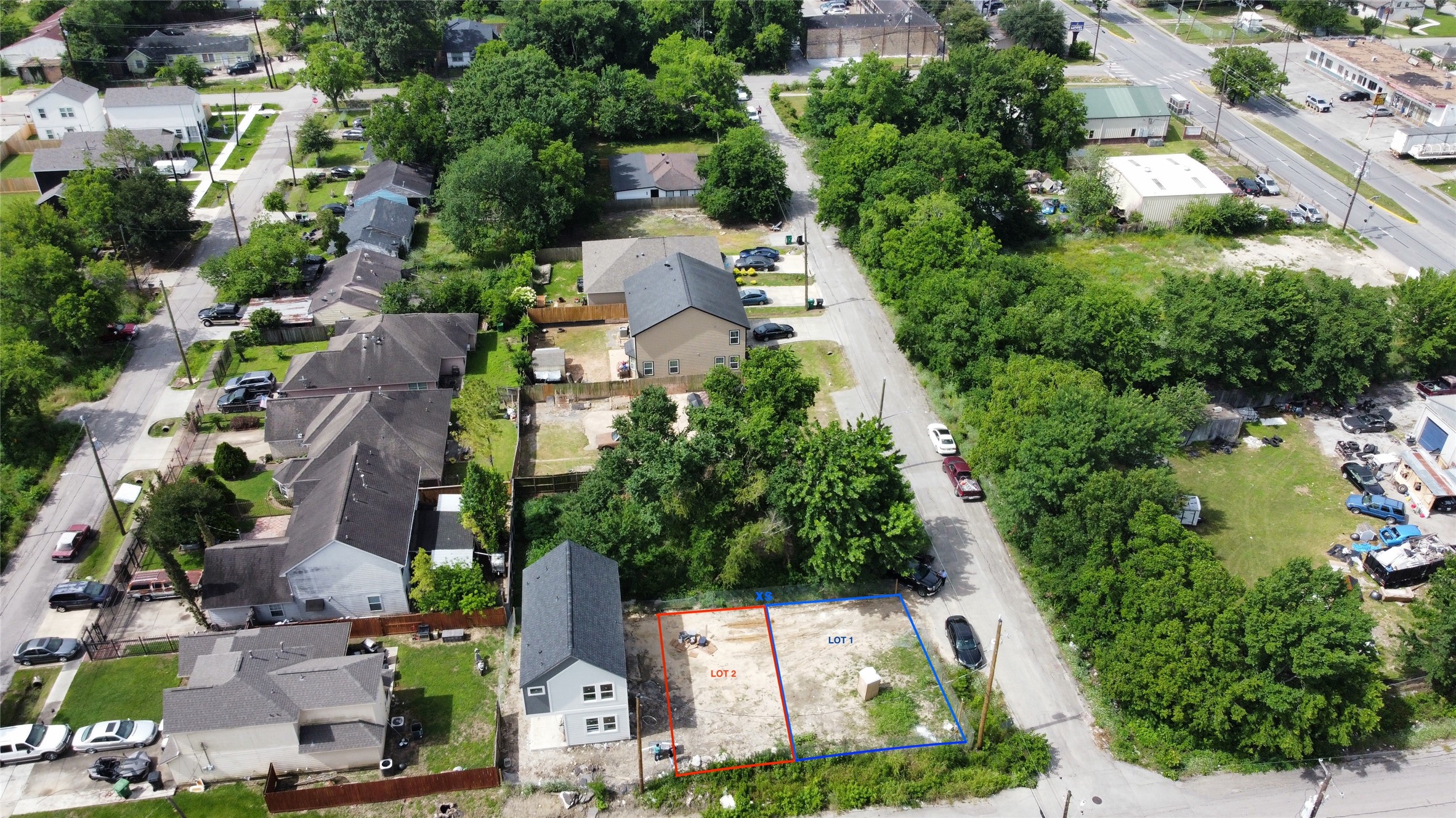 an aerial view of residential houses with outdoor space