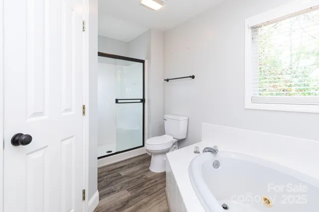 a bathroom with a tub and shower