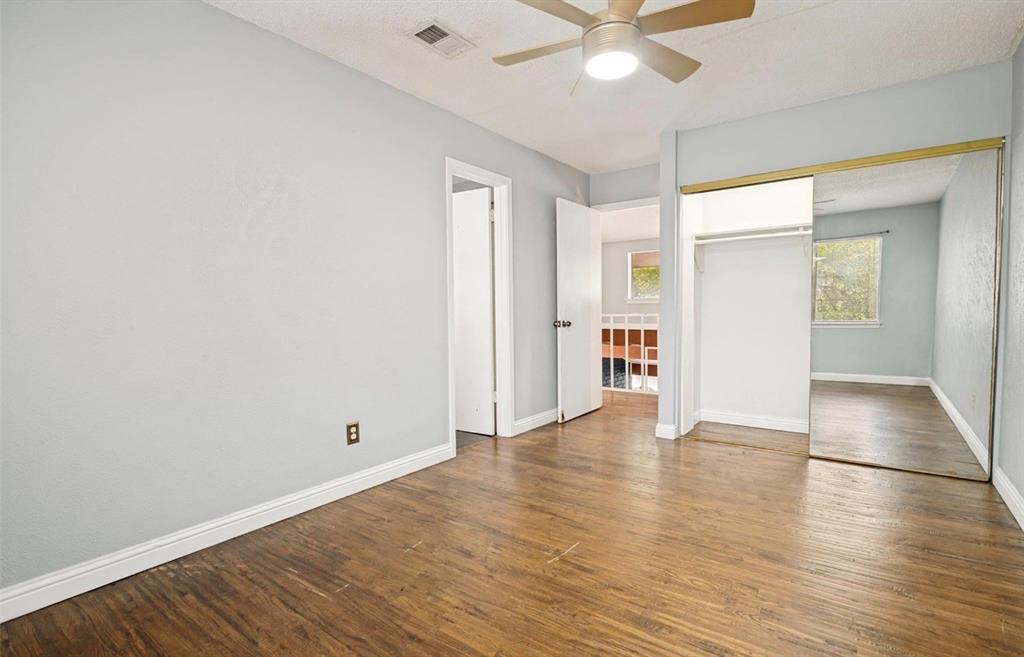 5808 Harvest Hill Road Dallas, TX 75230 - Photo 15 of 18 Room with wood-finish flooring, light blue wall paint, and white trim