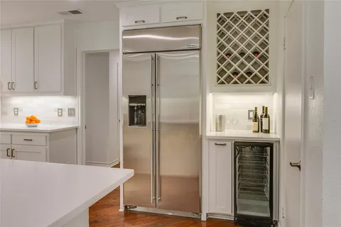 a kitchen with a refrigerator and cabinets