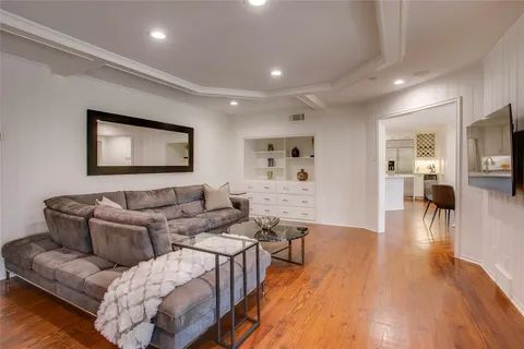 a living room with furniture and wooden floor