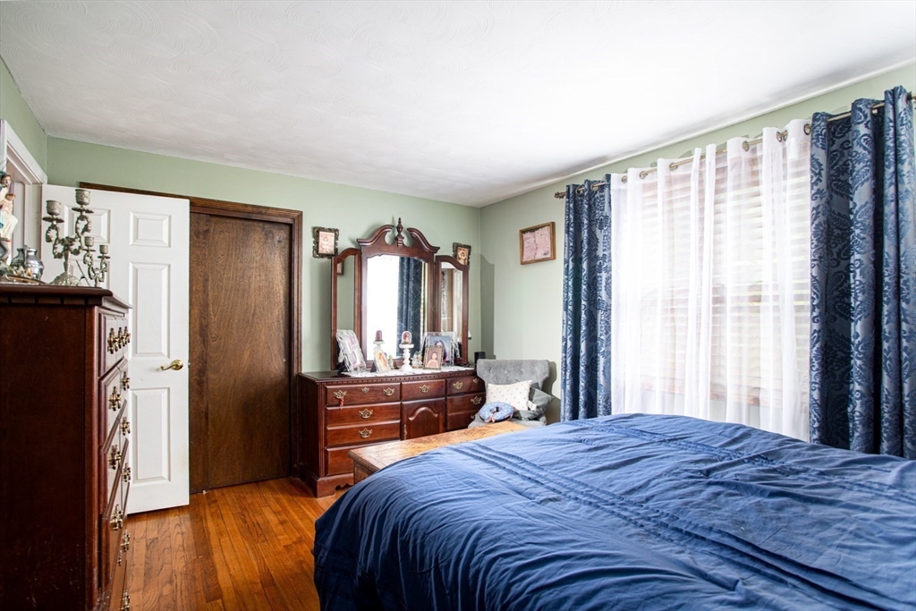 166 Stonehaven Road Fall River, MA 02723 - Photo 15 of 33 a bedroom with a bed dresser and a large window