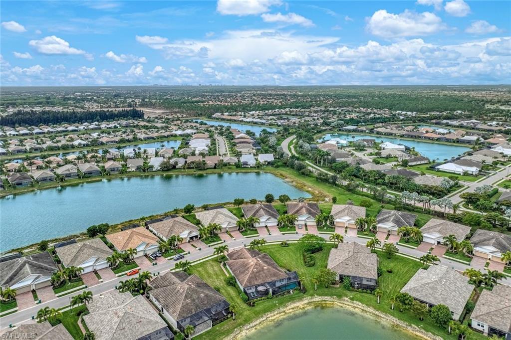14822 Edgewater Circle Naples, FL 34114 - Photo 27 of 28 an aerial view of lake residential house with outdoor space and trees around