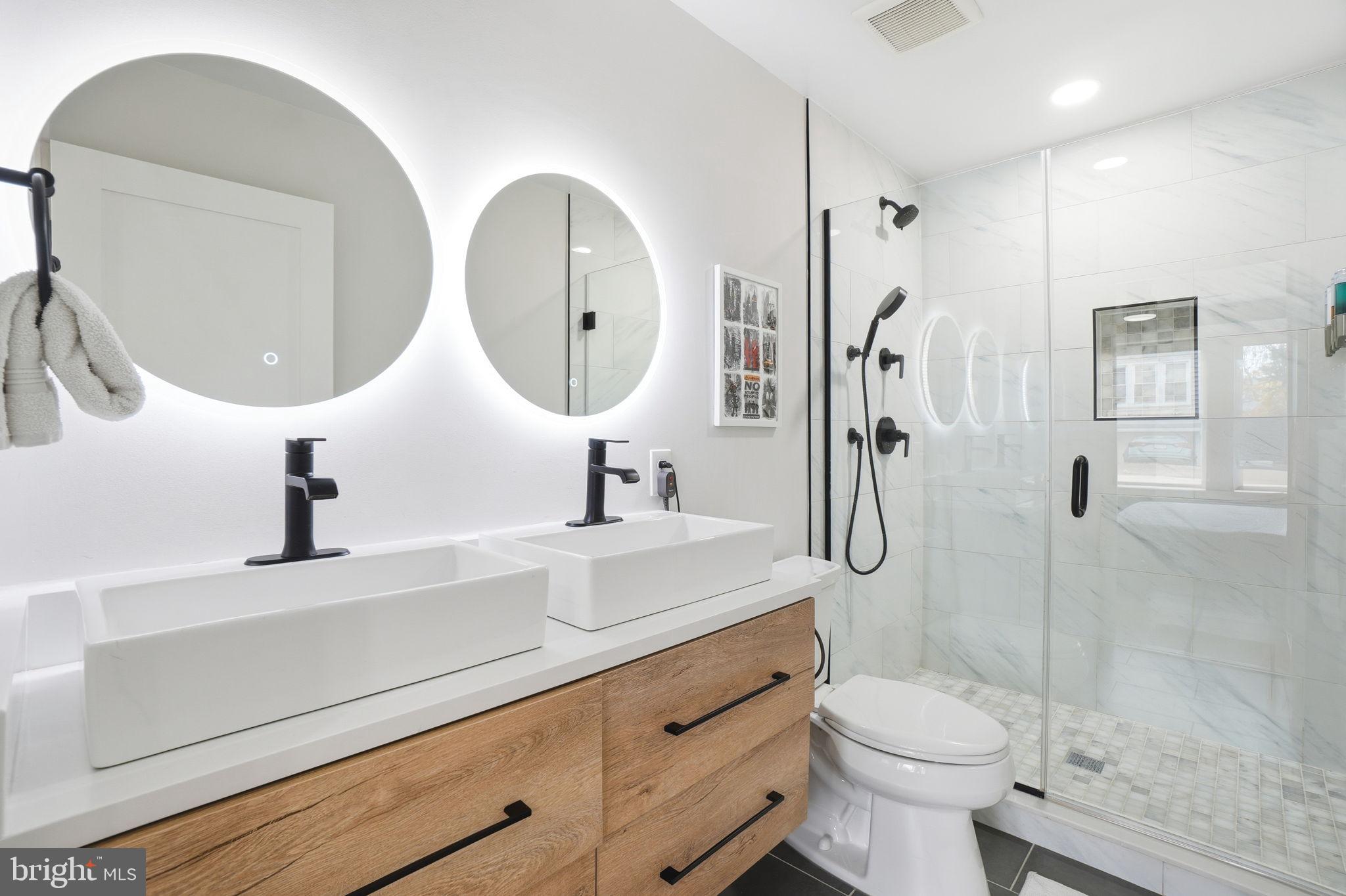 616 Quebec Place Northwest, Unit 1 Washington, DC 20010 - Photo 15 of 26 a bathroom with a sink a toilet and a mirror