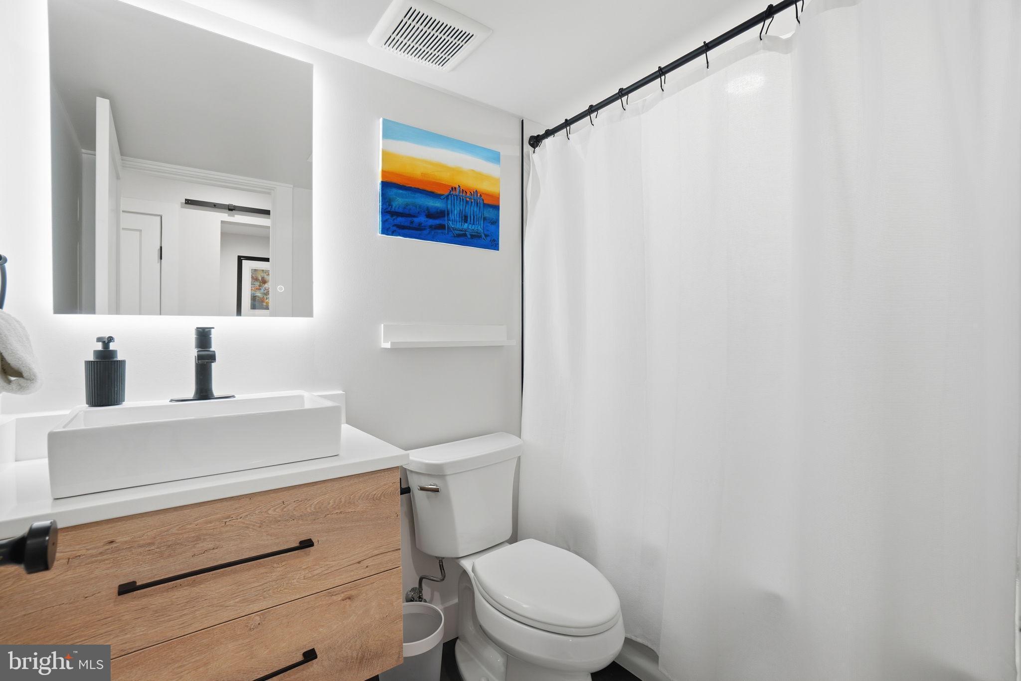 616 Quebec Place Northwest, Unit 1 Washington, DC 20010 - Photo 18 of 26 a white toilet sitting next to a bathroom sink